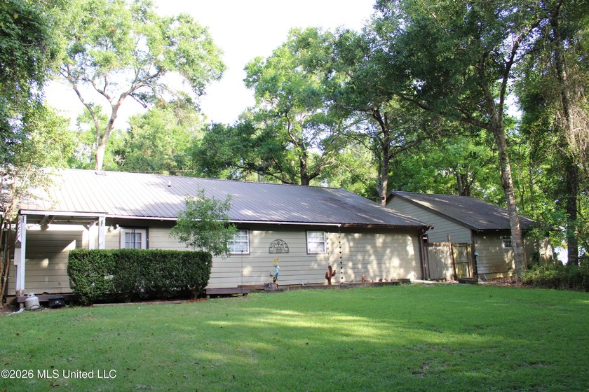 This home features an open floor plan, lots of shade from the - photo 13
