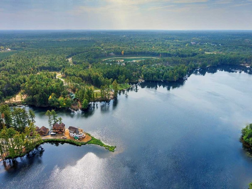 Over 60' of frontage on beautiful NEPCO Lake. This wooded lot - photo 8