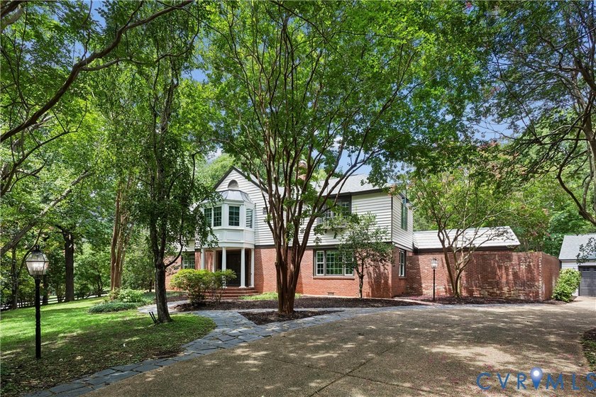 Hidden among mature trees on a rare double lot, this exceptional - photo 2