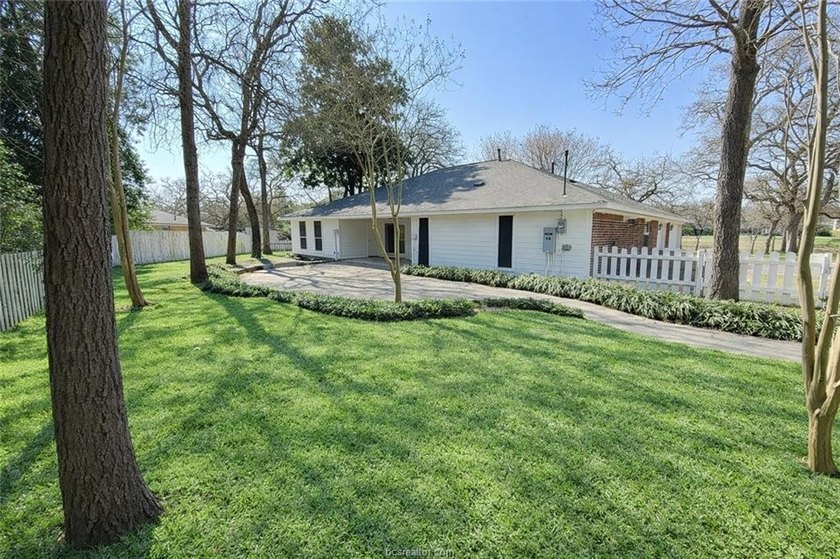 Situated on nearly three-quarters of an acre beneath mature - photo 15