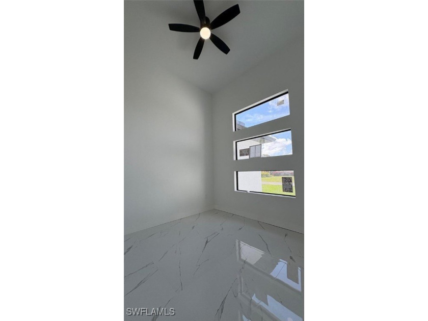This stunning new construction features impact windows and doors - photo 7