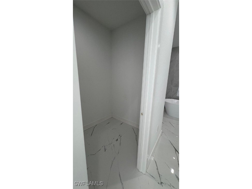 This stunning new construction features impact windows and doors - photo 10