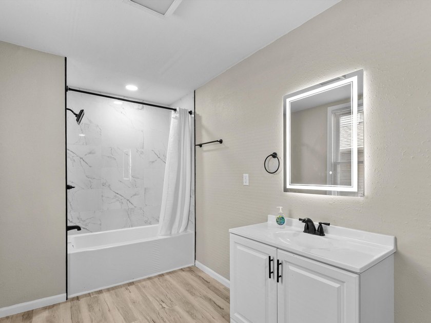 This beautifully renovated 5-bedroom, 2-bath home has been - photo 13
