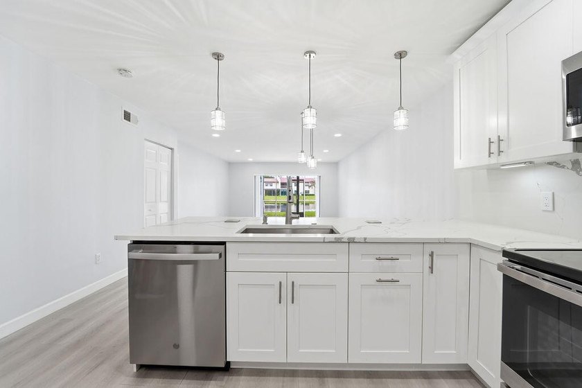 FULLY RENOVATED, 1st-FLOOR, LAKE FRONT condo located in the - photo 2
