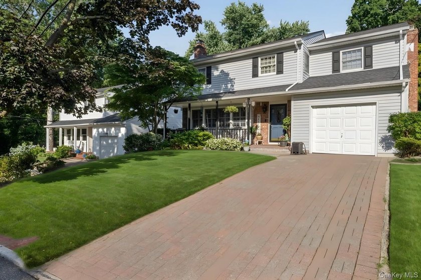 The brick driveway and lovely porch welcome you to this turnkey - photo 2