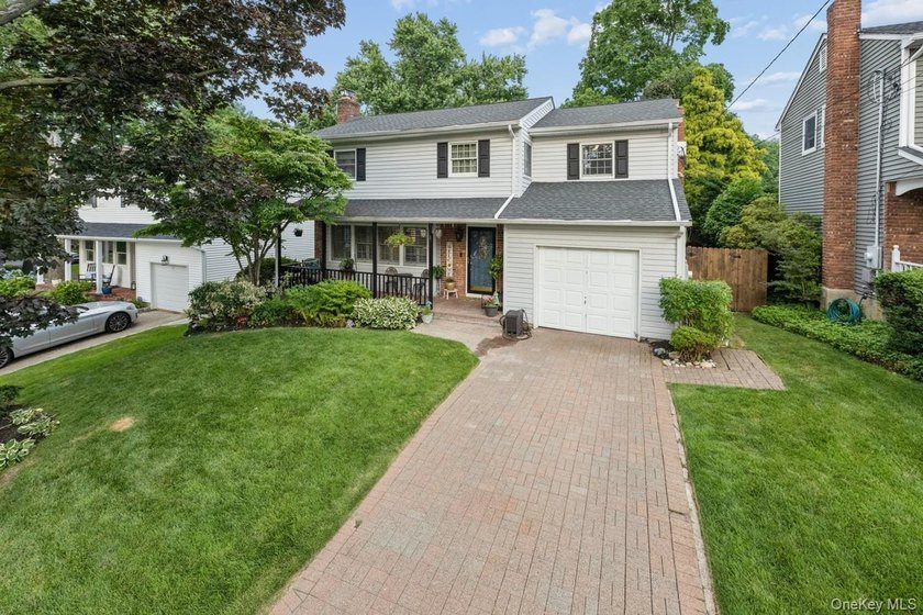 The brick driveway and lovely porch welcome you to this turnkey - photo 4