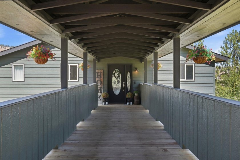 Situated on a sprawling 23-acre property along the serene shores - photo 2