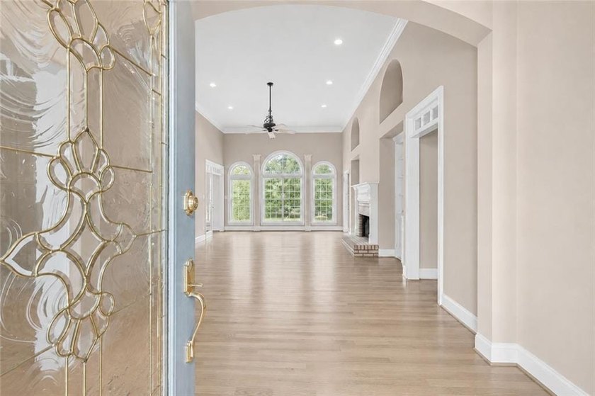 This exquisite four-sided blush brick estate is the epitome of - photo 8