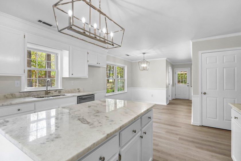 TOTALLY RENOVATED, ALL NEW KITCHEN, FRESH PAINT, NEW FLOORING - photo 13