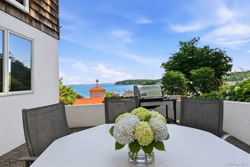 Nestled into the hillside with water views that hold through - photo 4