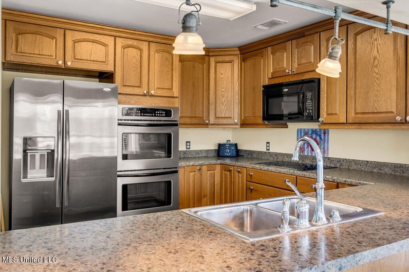 Located on a spacious waterfront lot in Bay St. Louis, this - photo 12