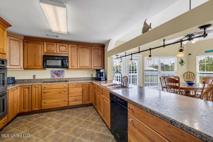 Located on a spacious waterfront lot in Bay St. Louis, this - photo 15