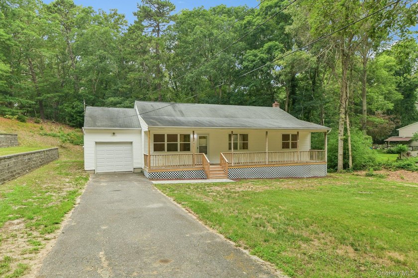 Tucked away on just over an acre in a private, wooded setting - photo 2