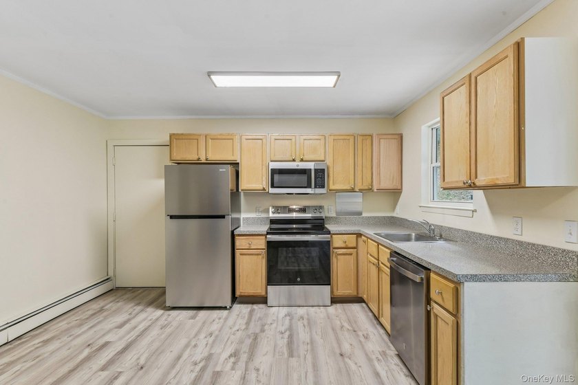 Tucked away on just over an acre in a private, wooded setting - photo 10