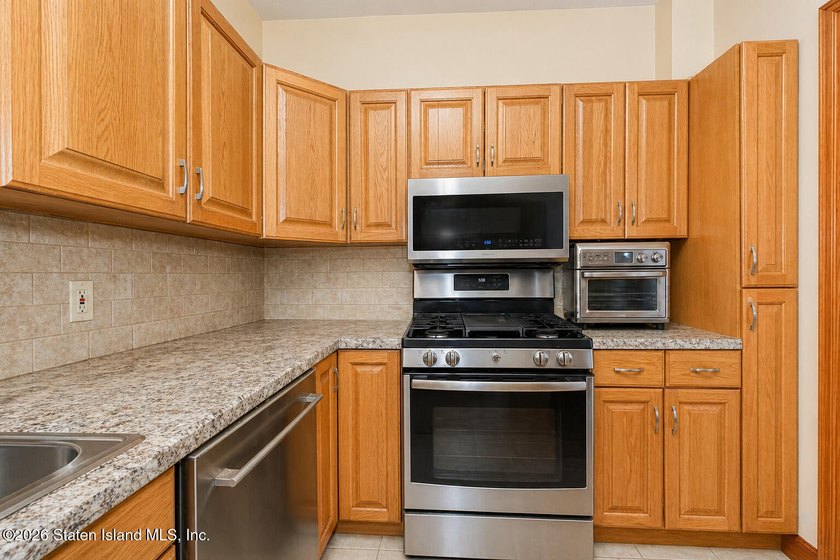 Located at 1879 Haring Street, this full brick end-unit - photo 11