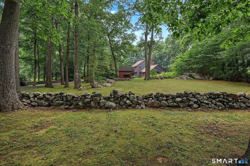 Set gracefully on a beautifully landscaped property framed by - photo 38