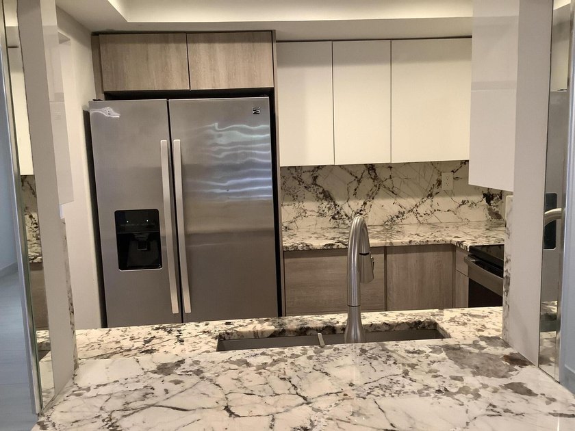 This beautifully renovated 2-bedroom, 2-bathroom townhouse is - photo 2