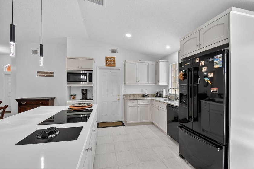 WOW - Awesome pool home with renovated kitchen, flooring and - photo 10