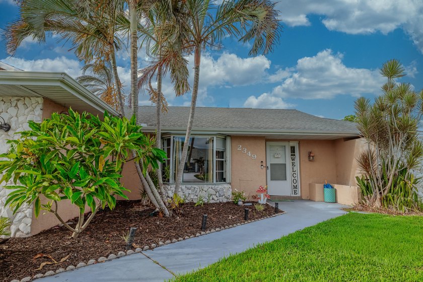 Welcome to this charming 2-bedroom, 2-bath pool home in the - photo 2