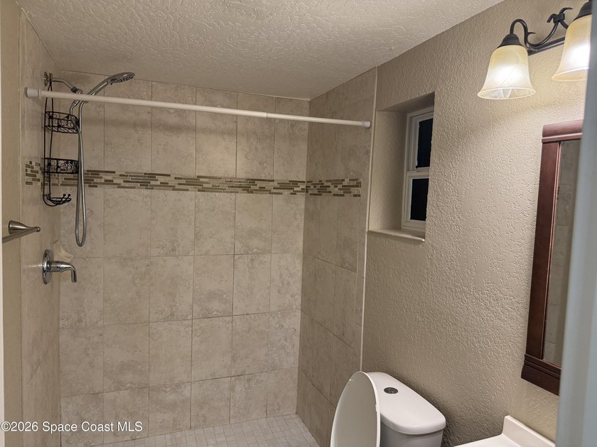 Step inside to find tile flooring flowing throughout the main - photo 18