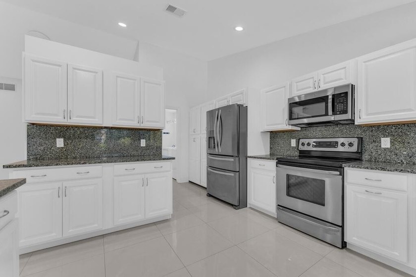 This stunning 4-bedroom, 2-bath pool home in the heart of Coral - photo 16