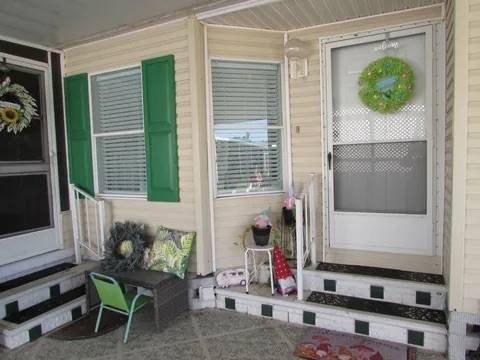 Entrance to this 2 bath 2-bedroom home is well under the car - photo 3
