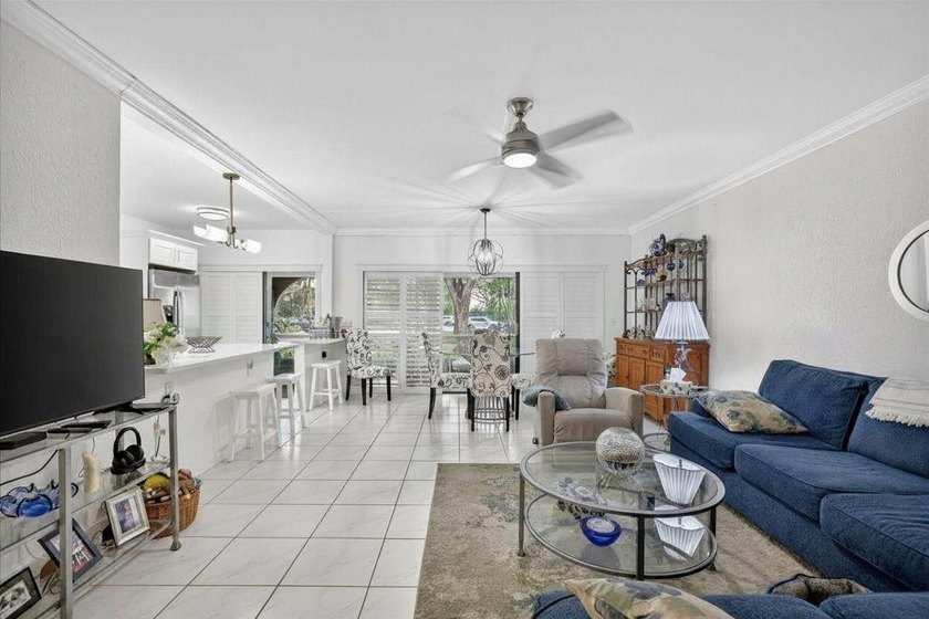 This spacious 2/2 ground-floor condo offers the perfect blend of - photo 2