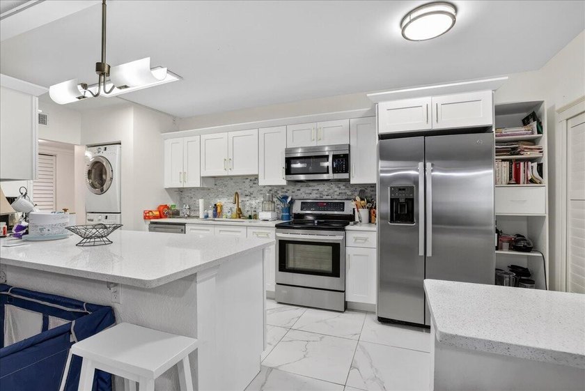 This spacious 2/2 ground-floor condo offers the perfect blend of - photo 7