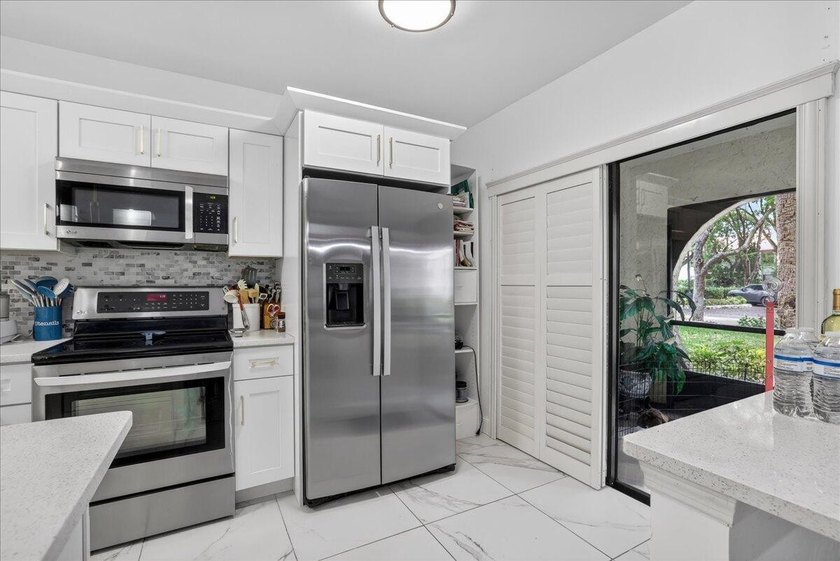 This spacious 2/2 ground-floor condo offers the perfect blend of - photo 10