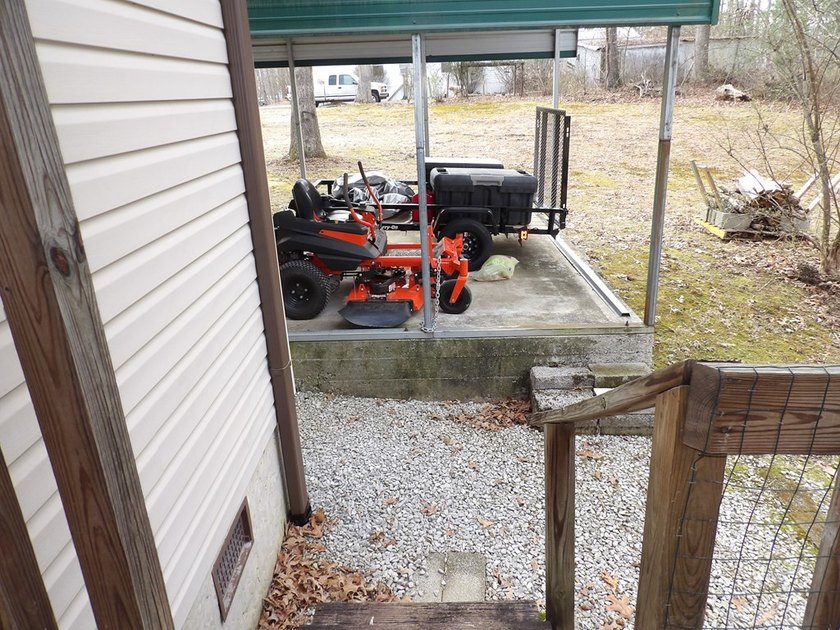 Well-maintained property featuring a 14' RV carport with hookups - photo 26