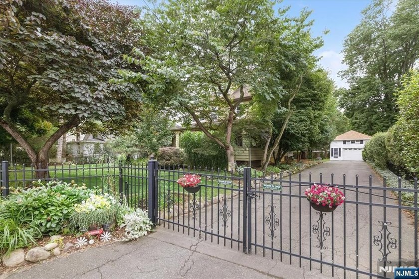 This home is gracefully positioned on a beautifully landscaped - photo 4