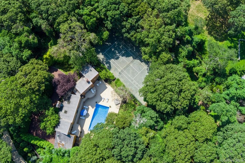 Tucked away on 1.4 acres of lush, landscaped grounds, this - photo 25