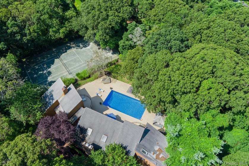 Tucked away on 1.4 acres of lush, landscaped grounds, this - photo 26