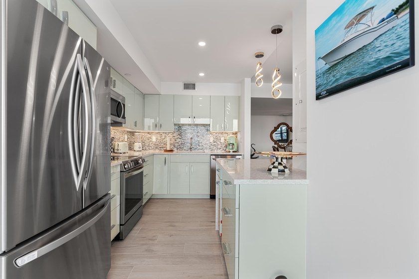 Experience elevated coastal living in this immaculate, fully - photo 17