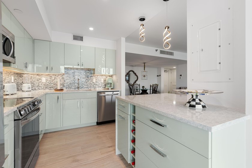 Experience elevated coastal living in this immaculate, fully - photo 19