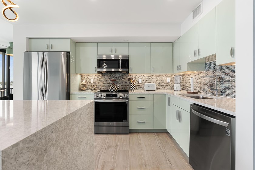 Experience elevated coastal living in this immaculate, fully - photo 20