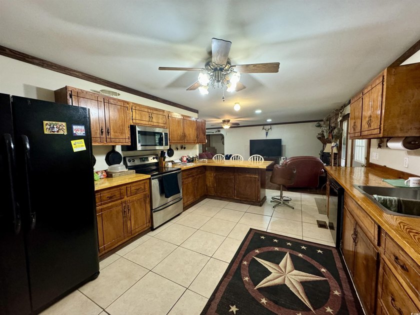 Lovely brick ranch-style home with just over 12 acres! Through - photo 4