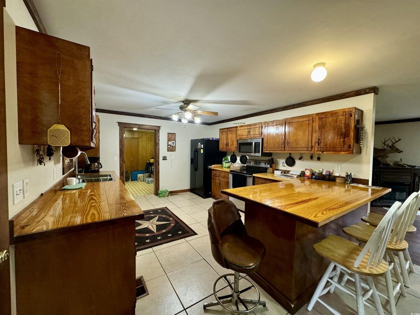 Lovely brick ranch-style home with just over 12 acres! Through - photo 5