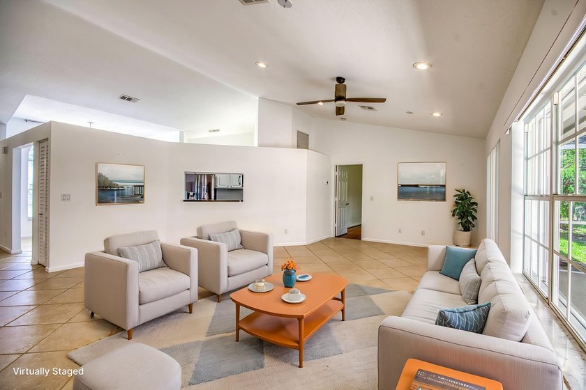 Manicured landscaping and soaring vaulted ceilings welcome you - photo 5