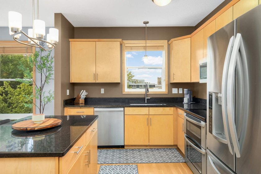 This beautifully updated end-unit condo is filled with natural - photo 7
