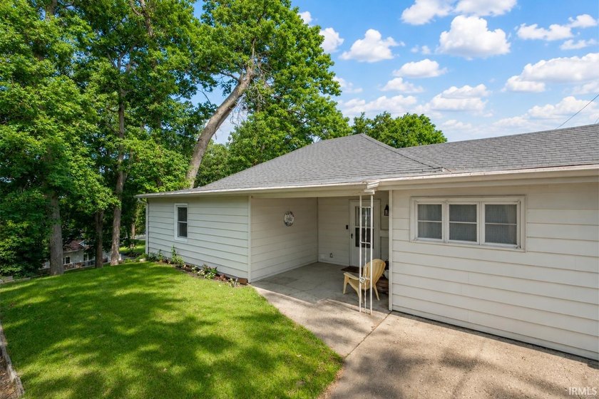 Tucked into a peaceful setting with mature trees and open green - photo 3
