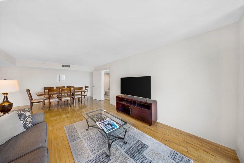 Brand-new floor-to-ceiling impact windows enhance this bright - photo 11