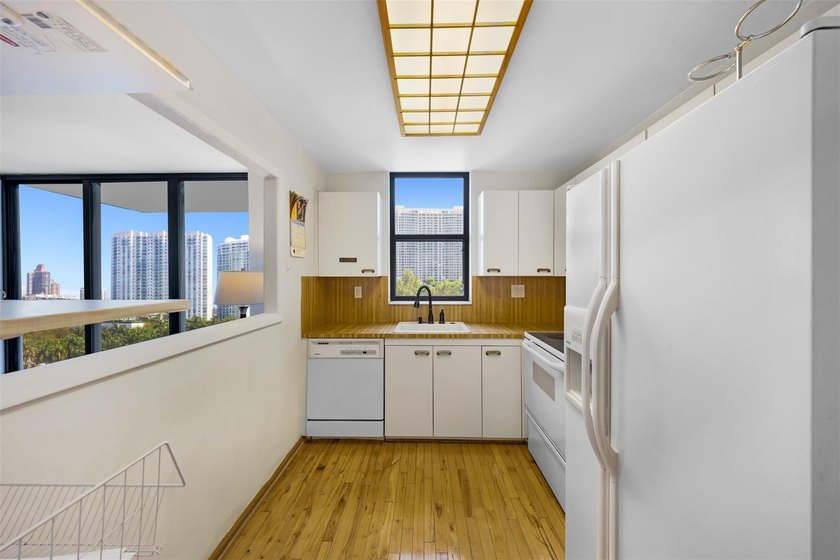 Brand-new floor-to-ceiling impact windows enhance this bright - photo 12