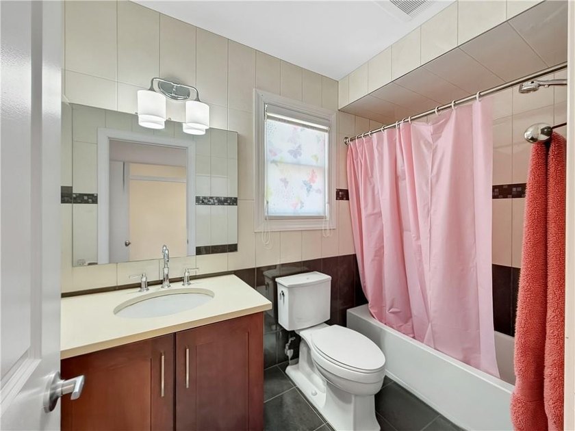 Built in 2013, this detached two-family home with brick front - photo 25