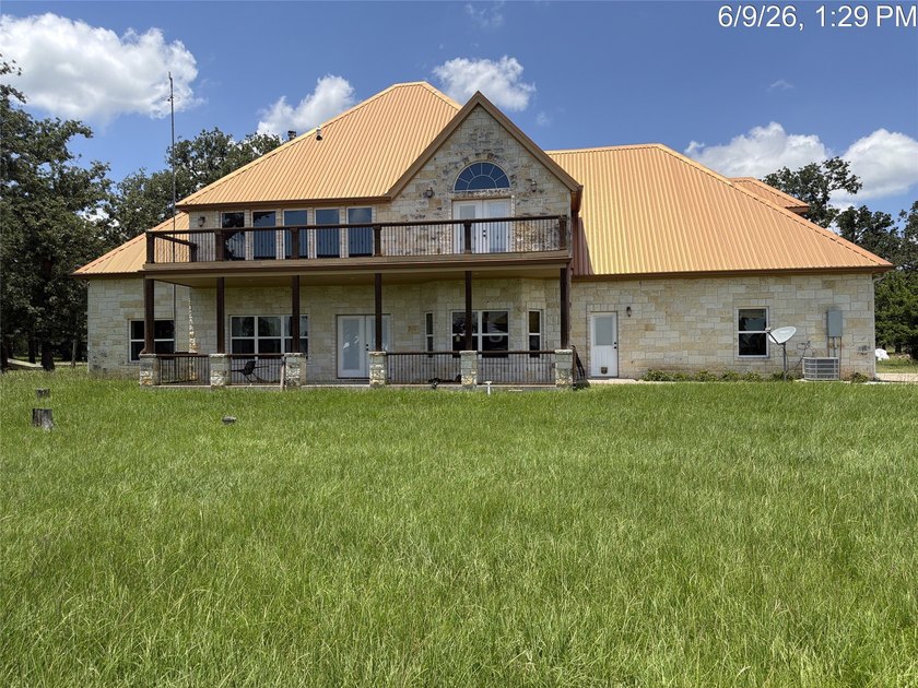 Set on 1.48 wooded acres along Lake Limestone, this custom stone - photo 3