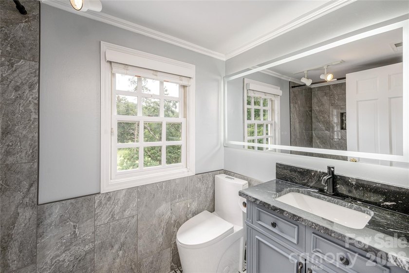 Set on a private .7-acre lot in North Asheville, this 3-bedroom - photo 22