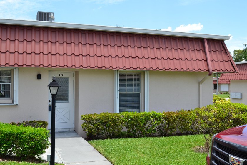 Welcome to this desirable 55+ community End-unit villa in the - photo 2