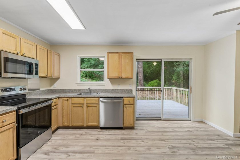 Tucked away on just over an acre in a private, wooded setting - photo 14