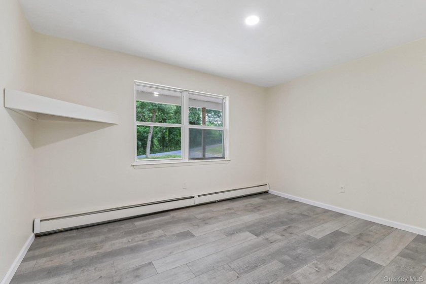 Tucked away on just over an acre in a private, wooded setting - photo 17