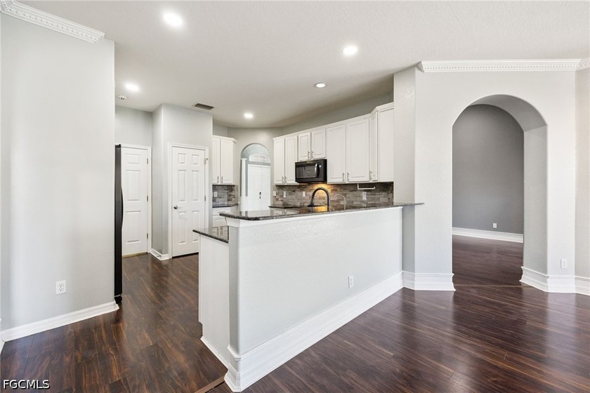 The spacious, open-concept floor plan features two living areas - photo 6